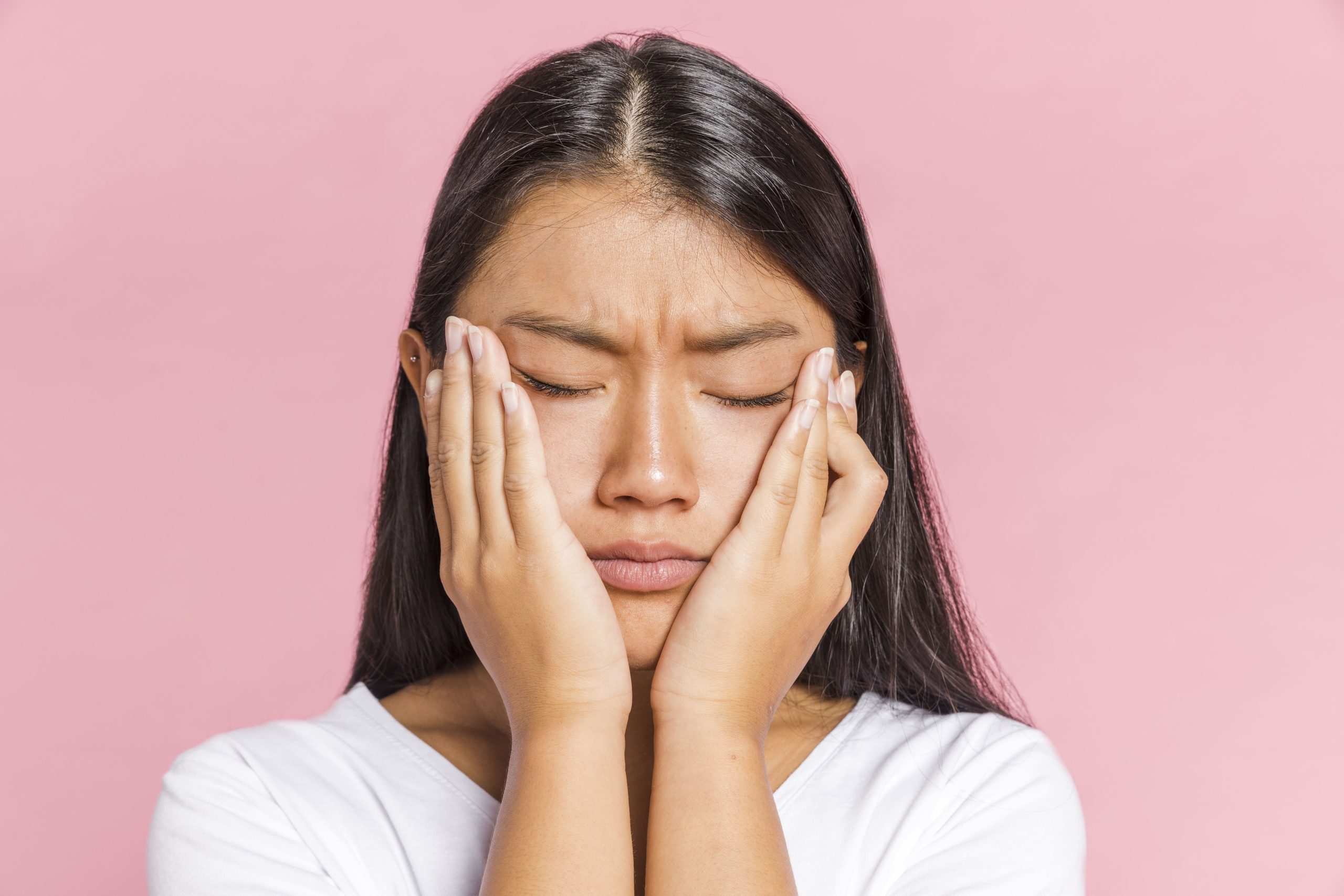 young lady cupping hands on face